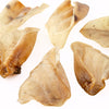 A group of 100% All-Natural Cow Ears (20 Pack) from Best Bully Sticks on a white surface.