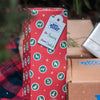 A Best Bully Sticks Holiday Stocking Stuffer Treat Box full of Christmas gifts with a gift tag on it.